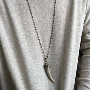 gray beaded necklace with bone horn charm